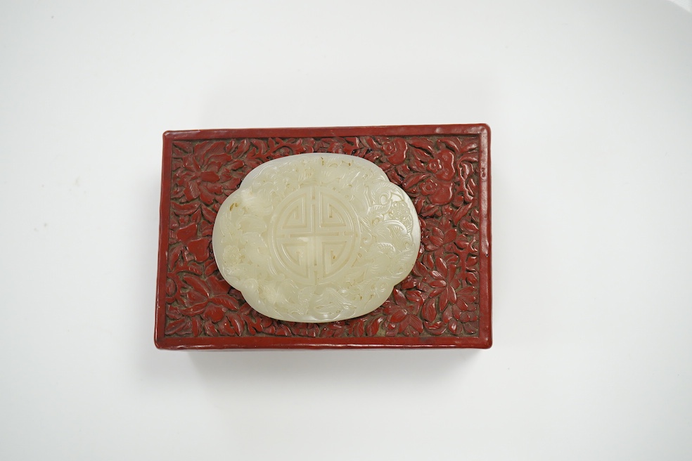 A Chinese carved jade mounted cinnabar lacquer box, 19th / 20th century, 14cm wide. Condition - fair, commensurate with age